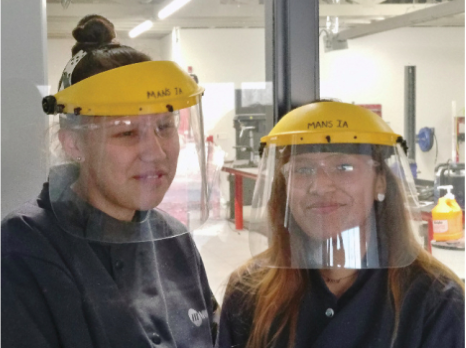 Seizing Equal Opportunity: These two Grade 10 girls love getting into the welding shop and working with big equipment to create their designs.