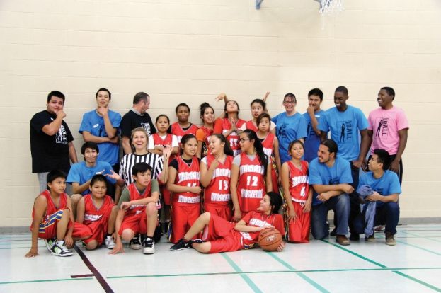 Joshua with MANS students and alumni having fun at the annual Alumni Basketball Tournament